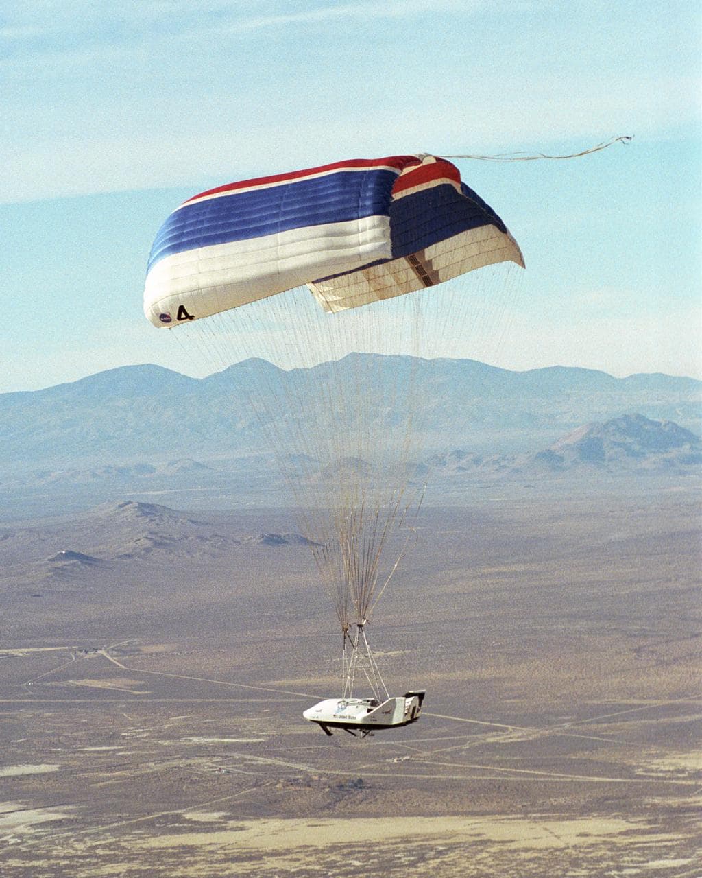 X-38 vehicle suspended under its 7,500-square-foot parafoil during a 2001 drop test at NASA Dryden